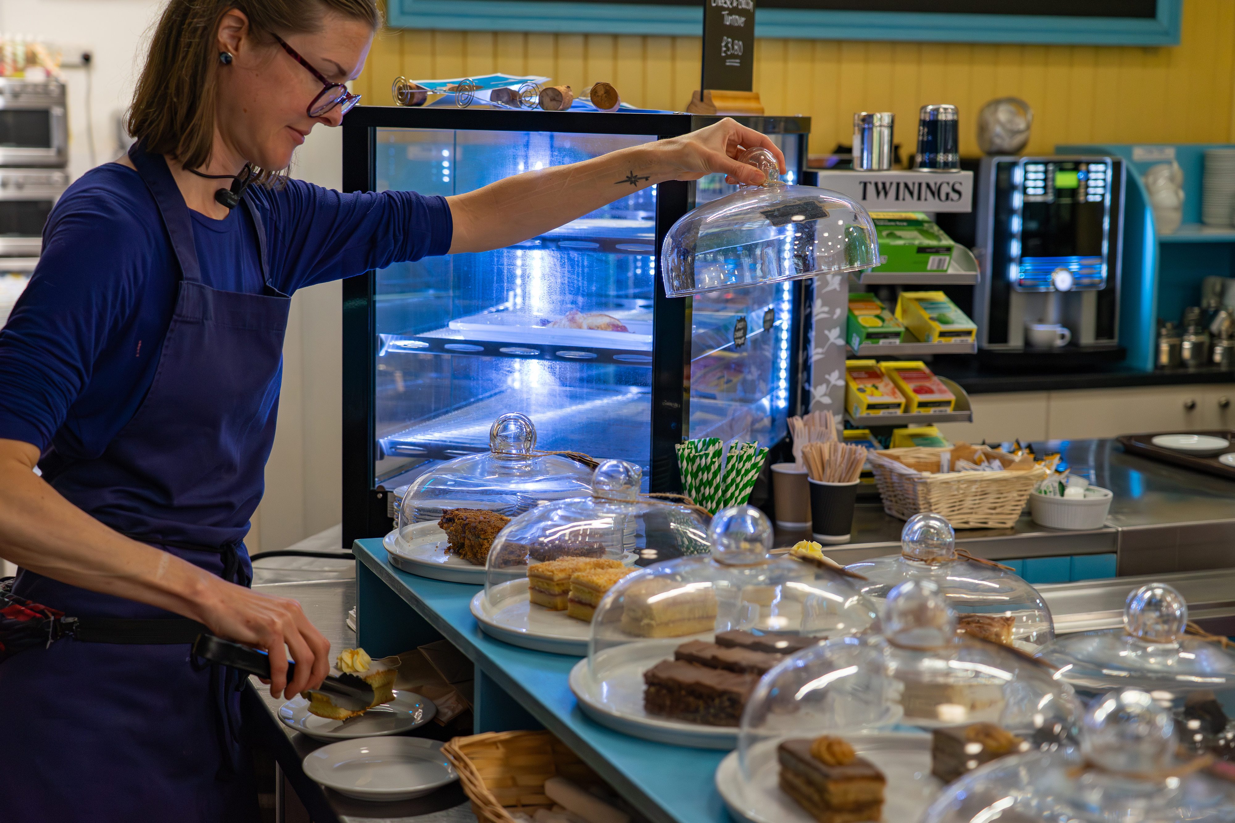 Member of staff behind the cake counter at the Whistlestop Cafe