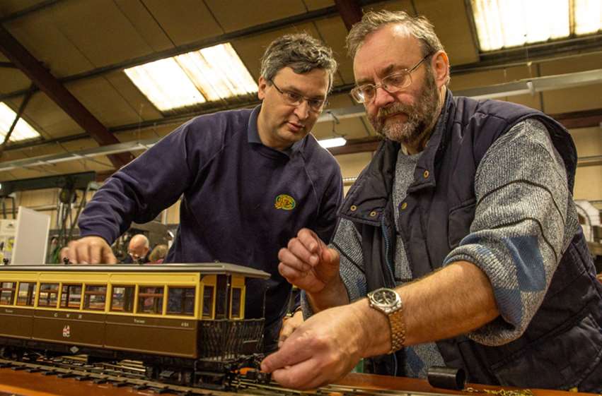 Minature train on track with Andrew in background